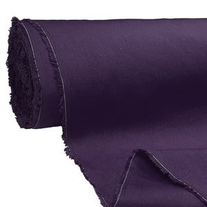 May include: A roll of dark purple fabric with a raw edge. The fabric is tightly rolled and has a soft, textured surface.