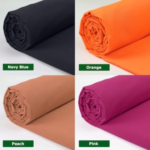 May include: Four rolls of fabric in navy blue, orange, peach, and pink. Each roll is labeled with its color name in a green rectangle. The fabric appears to be tightly rolled, showcasing the color and texture of the material.
