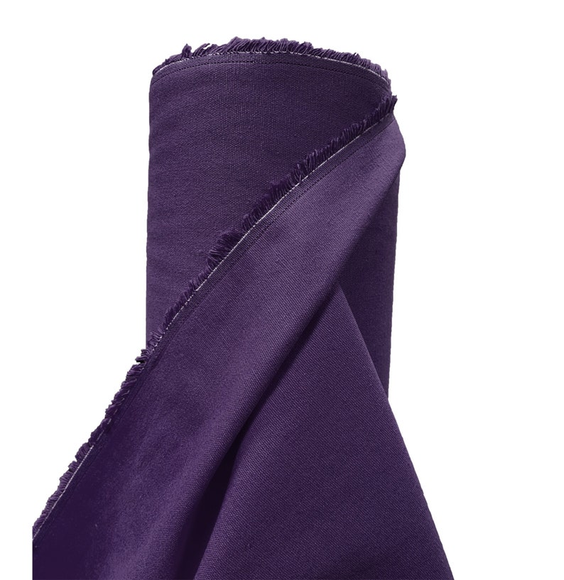 May include: A roll of purple fabric with a raw edge. The fabric is folded in half and the edges are frayed.
