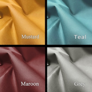 May include: Close-up of four fabric swatches in different colors: mustard yellow, teal blue, maroon red, and light gray. The fabric has a textured, woven appearance.