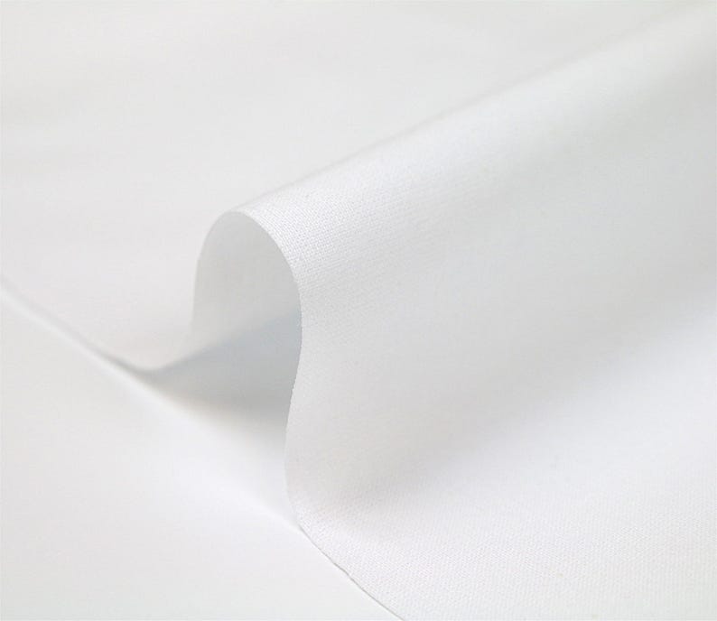 May include: White fabric with a smooth, even texture. The fabric is folded over, creating a soft curve.