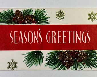 May include: A vintage Christmas card with a red banner that reads "Season's Greetings". The banner is surrounded by green pine branches with brown pine cones and red berries. There are also green snowflakes on the card.