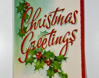 May include: A vintage Christmas card with a red and green holly sprig and the text "Christmas Greetings".