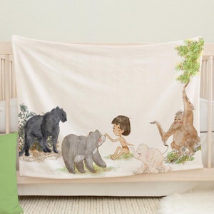 May include: A white fleece blanket with a watercolor illustration of a boy, a black panther, a bear, an elephant, and an orangutan. The illustration is set in a jungle scene with green leaves and trees.