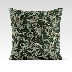 May include: A green throw pillow with a repeating pattern of stylized lizards and leafy branches.