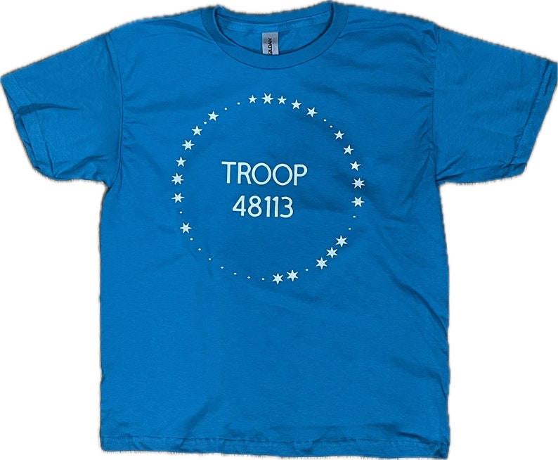 May include: A turquoise blue t-shirt with a white circle design featuring a ring of stars and the text "TROOP 48113".