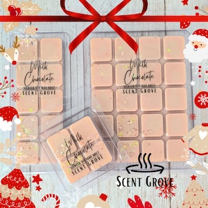 May include: Light brown milk chocolate scented soy wax melts in clear plastic containers. The melts have glitter accents. The text "Milk Chocolate" and "Scent Grove" are printed on the containers. Festive holiday decorations surround the melts.