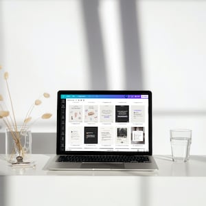 May include: A laptop computer with a white background. The laptop screen displays a social media management tool with several pre-designed templates for Instagram posts. The templates feature various designs and text.