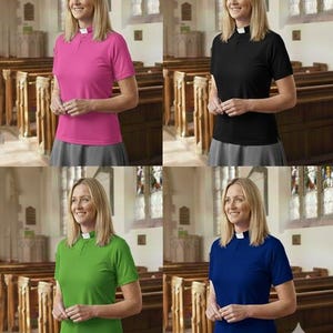 May include: A short-sleeved clergy shirt with a white tab collar, available in pink, black, green, and blue. The shirt features a buttoned placket and a straight hem, paired with a grey skirt. The design includes a structured collar insert.