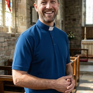 Op de afbeelding: Een donkerblauw poloshirt met korte mouwen, voorzien van een gestructureerde kraag met een witte boordinsert bij de halslijn. Het shirt heeft een knoopsluiting, een textuur in de stof en een rechte zoom voor een nette en uniforme uitstraling.