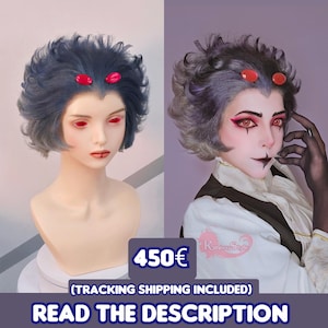 May include: A blue-grey wig with short, wavy hair and two red accents. The wig is displayed on a mannequin head. The image also shows a person wearing the wig with dramatic makeup. The text on the image says "READ THE DESCRIPTION".