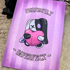 May include: A purple background with a white and black stitched plush toy holding a pink heart. The text "PERFECTLY IMPERFECT" is written in a stylized font.