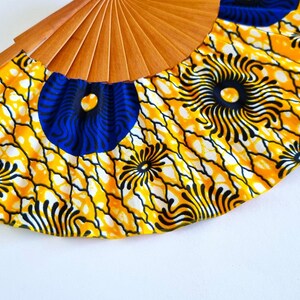 Colorful hand-crafted hand fan made of wood and African wax print fabric in yellow tones – a unique work of art for every occasion! image 5