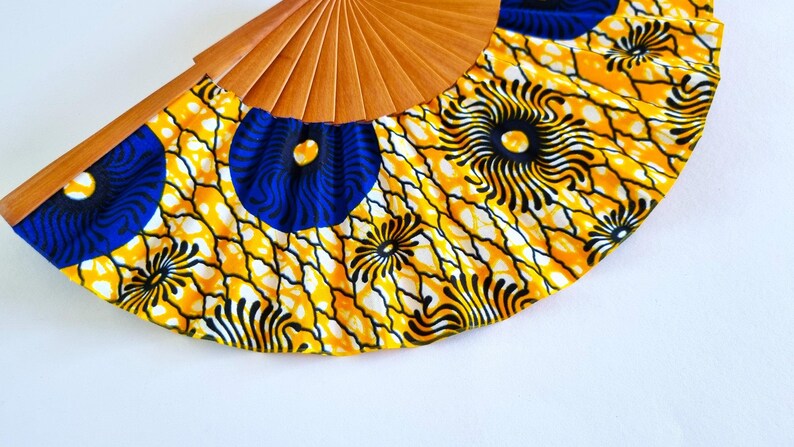 Colorful hand-crafted hand fan made of wood and African wax print fabric in yellow tones – a unique work of art for every occasion! image 5