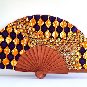 Colorful handmade hand fan made of wood and African wax print fabric in warm colors - perfect for your everyday life!