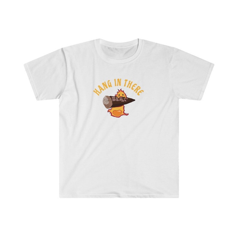 May include: White t-shirt with a cartoon image of a fire elemental holding a burning log. The text "Hang in there" is written in a yellow arc above the image.