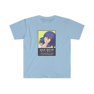 May include: A light blue t-shirt with a graphic of an anime character with blue hair. The graphic is surrounded by a yellow border and includes the text "SAD BOYS", "悲しい男の子", "I see no point in living if I can't be beautiful".