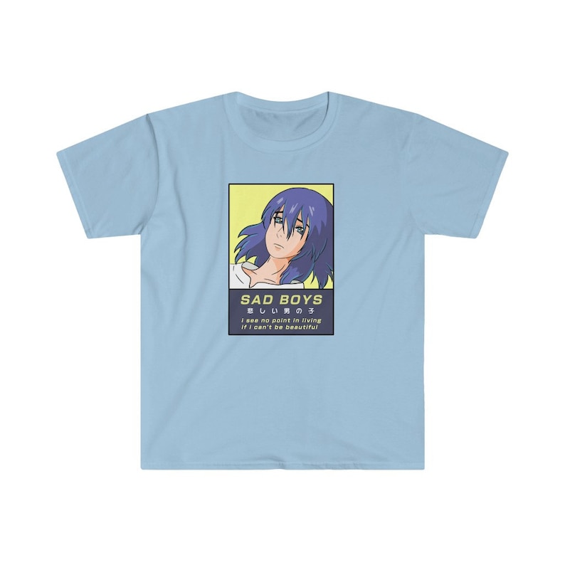 May include: A light blue t-shirt with a graphic of an anime character with blue hair. The graphic is surrounded by a yellow border and includes the text "SAD BOYS", "悲しい男の子", "I see no point in living if I can't be beautiful".