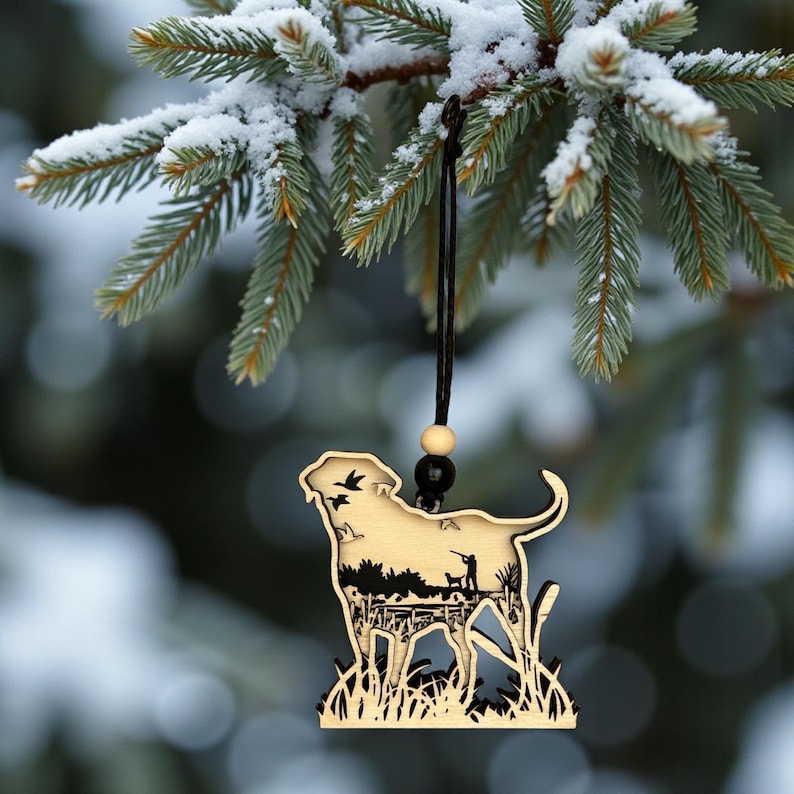 A Christmas Tree with pinecones and berries featuring a wood four layered Labrador Retriever Ornament with a duck hunting scene engraved on it.