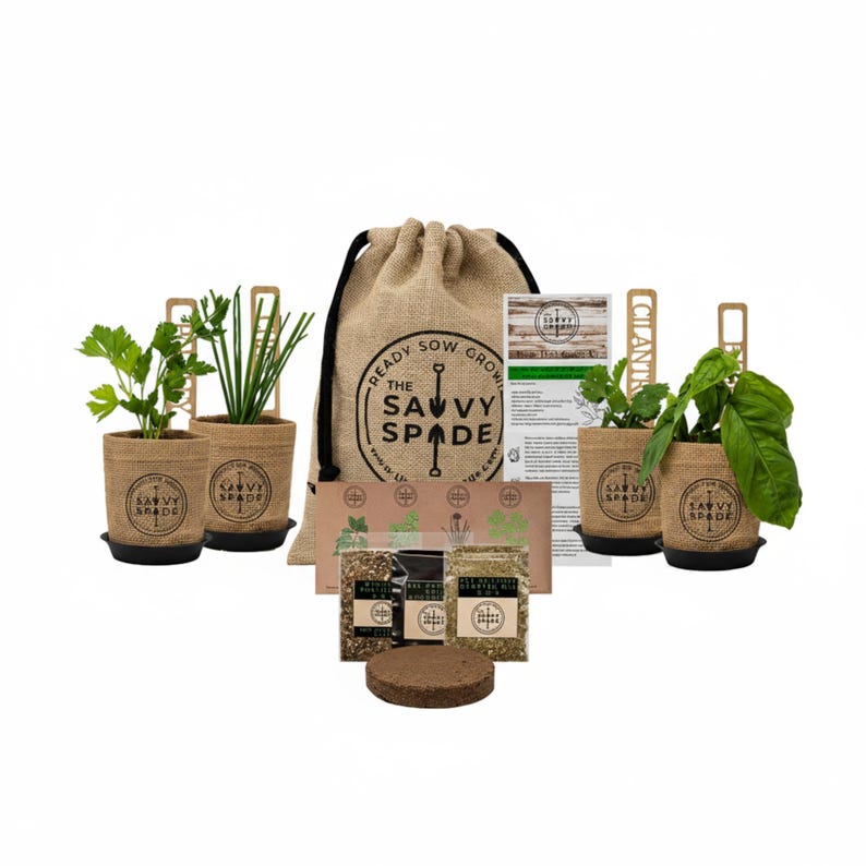Burlap herb garden pots planted with basil, oregano, cilantro and parsley.  A coco soil puck, organic fertilizer packet, seed packets, instructions and the burlap bag that all of the contents come packaged in.