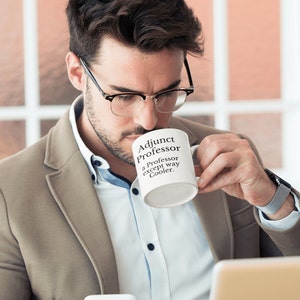 May include: White coffee mug with black text that reads "Adjunct Professor - a professor except way cooler."