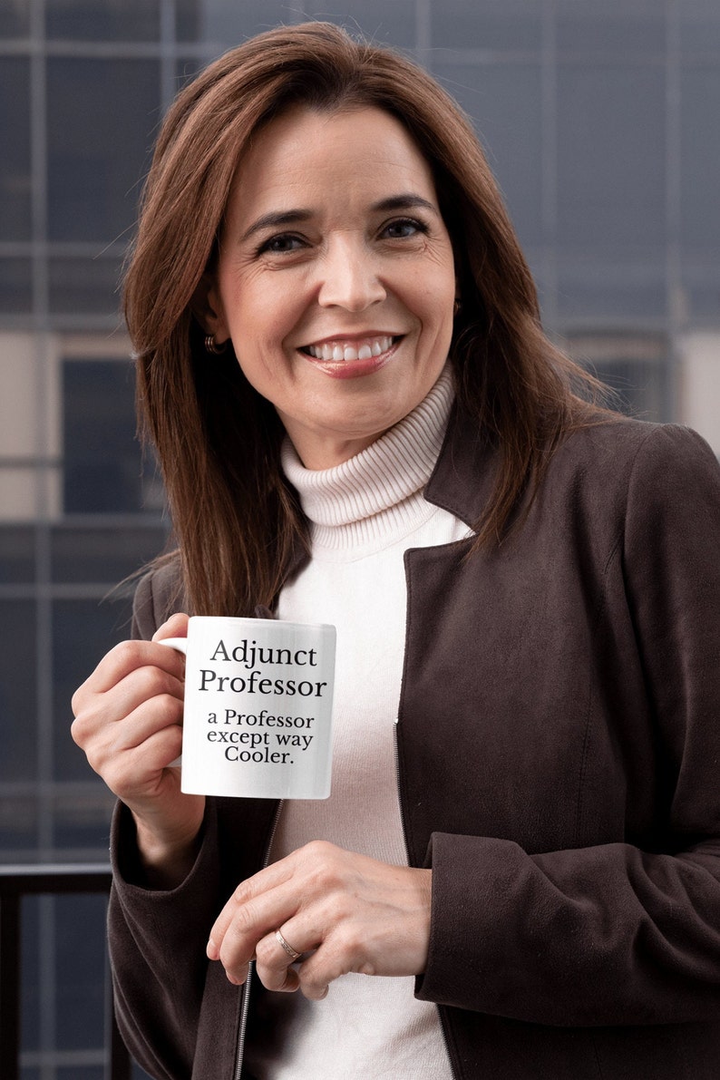 May include: White ceramic mug with black text that reads "Adjunct Professor a Professor except way Cooler."