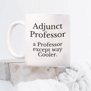 May include: White ceramic coffee mug with black text that reads "Adjunct Professor a Professor except way Cooler."