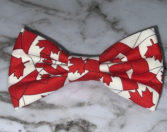 May include: A white bow tie with a red and white Canadian flag pattern.