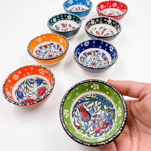 May include: Set of ten small ceramic bowls with colorful floral patterns. The bowls are approximately 3 inches in diameter and are perfect for serving dips, sauces, or snacks.
