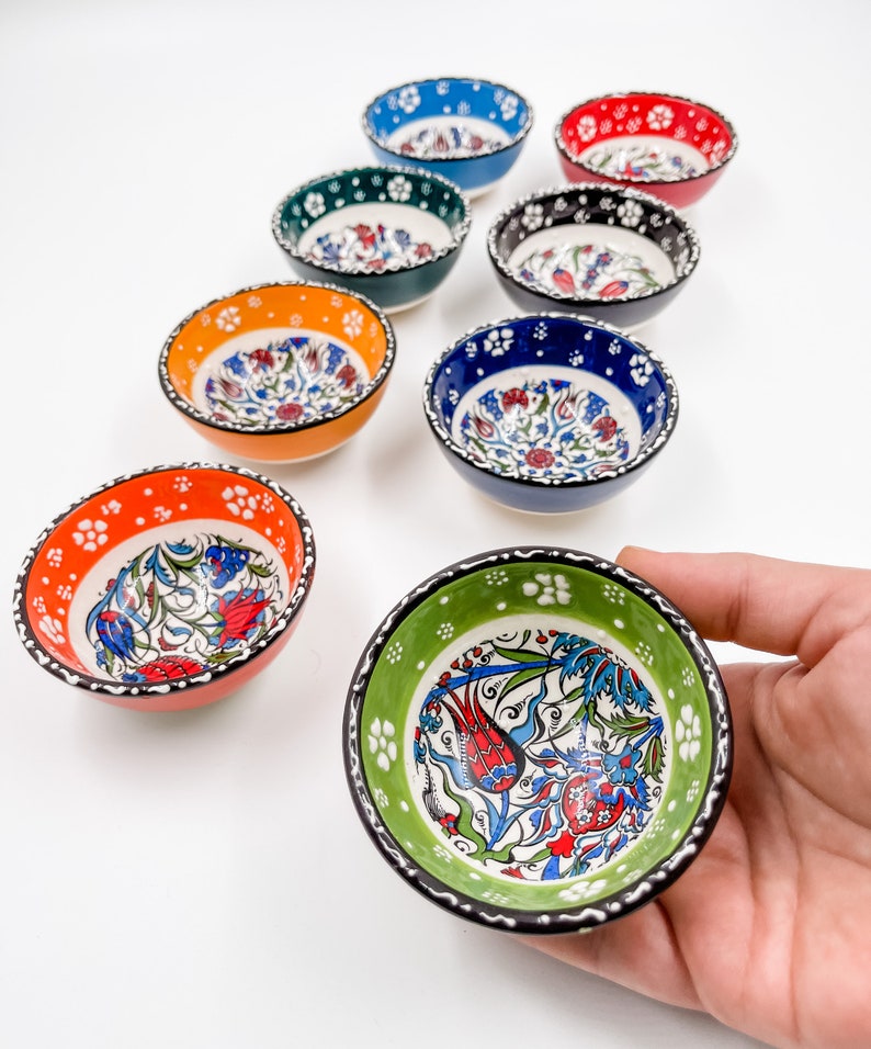 May include: Set of ten small ceramic bowls with colorful floral patterns. The bowls are approximately 3 inches in diameter and are perfect for serving dips, sauces, or snacks.