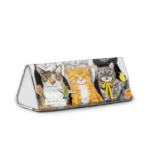 May include: A triangular eyeglasses case featuring a colorful illustration of several cats with a hummingbird and a yellow bow tie. The case has a white leather-like texture on the sides and a zipper closure.