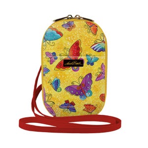 May include: A yellow crossbody bag with a red strap and a colorful butterfly print. The bag has a zipper closure and a small pocket on the front. The bag is made of leather and has a shiny finish.