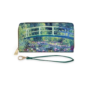 May include: A green and blue wallet with a painting of a bridge over a pond with water lilies. The wallet has a gold zipper and a green wrist strap.