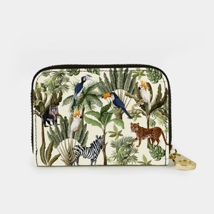May include: A white zippered wallet with a tropical jungle print. The print features toucans, parrots, monkeys, zebras, and leopards.