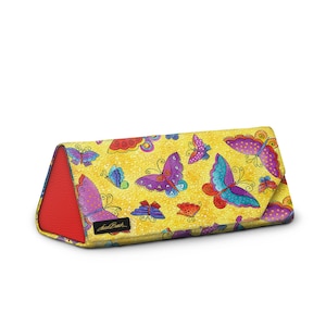 May include: A yellow, triangular glasses case with a vibrant butterfly pattern in purple, blue, and red. The case has a red interior and the brand name "Jack Bush" is printed on the side.