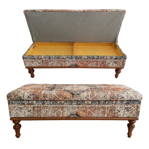 May include: A rectangular storage ottoman with a patterned fabric top and wooden legs. The top lifts to reveal a storage compartment.