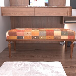 a modern living room with a wooden bench and a white rug on the floor.