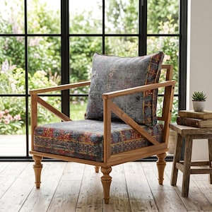 a wooden chair with a colorful patterned cushion, placed in front of a large window overlooking a garden.