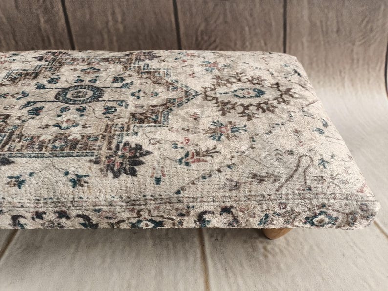 a decorative rug or cushion with a floral pattern on a wooden surface.