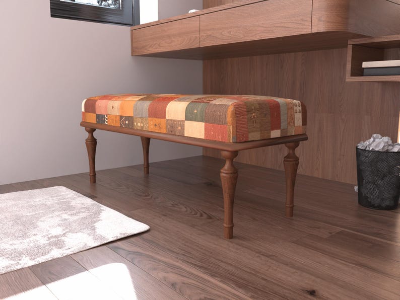 a wooden bench with a colorful, patchwork-style cushion on a hardwood floor.