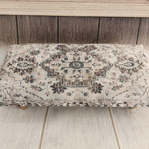 a decorative rug or cushion placed on a wooden surface.