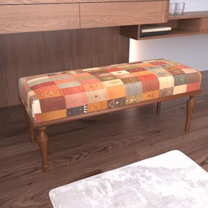 a wooden bench with a colorful, patchwork-style cushion on top, situated on a hardwood floor.