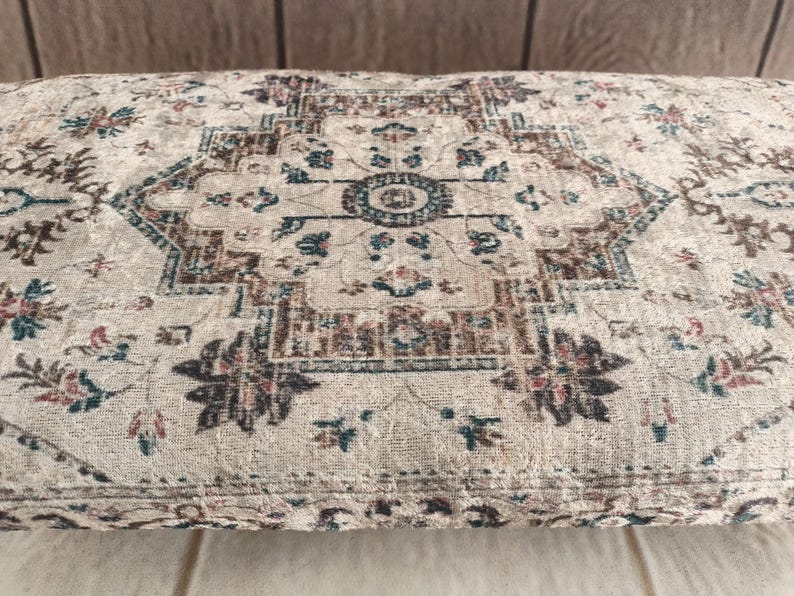 a close-up view of a decorative rug or cushion with a floral pattern.