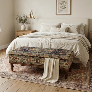 a cozy and inviting bedroom with a large bed, a wooden nightstand, and a decorative rug on the floor.