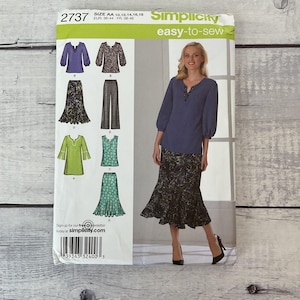 May include: Simplicity sewing pattern 2737 for size AA 10, 12, 14, 16, 18. The envelope features illustrations of a blue blouse, a patterned skirt, wide-leg trousers, and a green tunic. A photograph shows a model wearing a blue blouse and a dark patterned skirt.