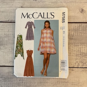 May include: McCall's sewing pattern M7565 featuring dress designs. The pattern includes a variety of styles, including a collared dress, a sleeveless dress, and a long dress with a belt. The size range is E5 (14-16-18-20-22).