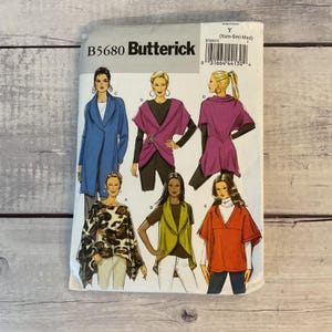 May include: A Butterick B5680 sewing pattern envelope featuring illustrations of various tops and jackets in blue, purple, leopard print, lime green, and orange. The package includes size Y for X-small, small, and medium, with a barcode on top.