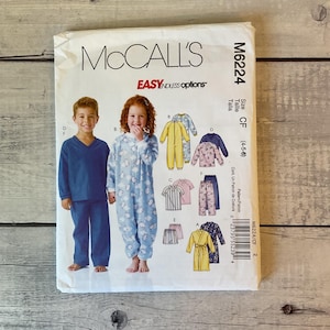 May include: McCall's M6224 sewing pattern envelope for children's sleepwear in size CF (4-5-6). The front features illustrations of pajamas, a jumpsuit, and a robe, with text including McCall's, M6224, Easy Endless Options, and size information.
