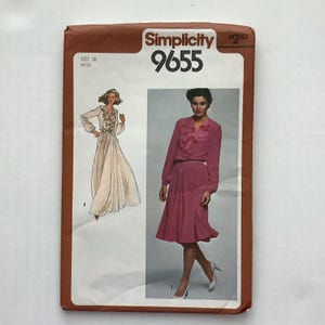 May include: A Simplicity 9655 sewing pattern envelope for a size 12 dress. The front features a brown border, the text Simplicity 9655, and illustrations of a long-sleeved dress with a ruffled front placket, shown in both a floor-length and knee-length version.