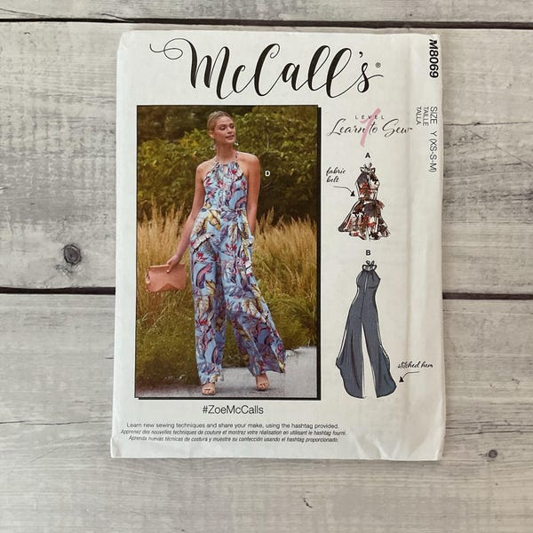 May include: McCall's sewing pattern featuring a jumpsuit design. The pattern includes a photo of the finished garment in a blue floral print. The pattern is labeled "Learn to Sew" and includes the hashtag #ZoeMcCalls.